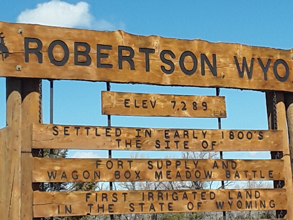 Robertson, Wyoming sign highlighting its historical significance, elevation of 7,289 feet, and references to early 1800s settlements and notable events.